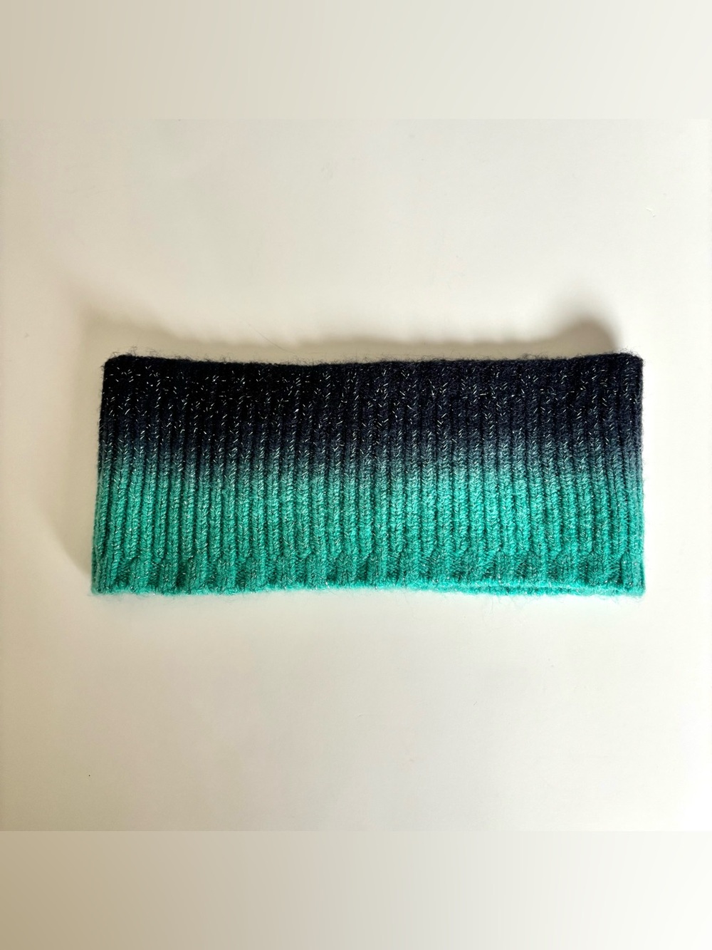 Ombre teal and navy knitted headband with gradient from navy to teal